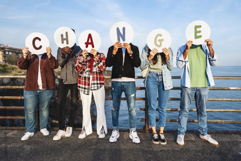diverse person holding letters spelled change